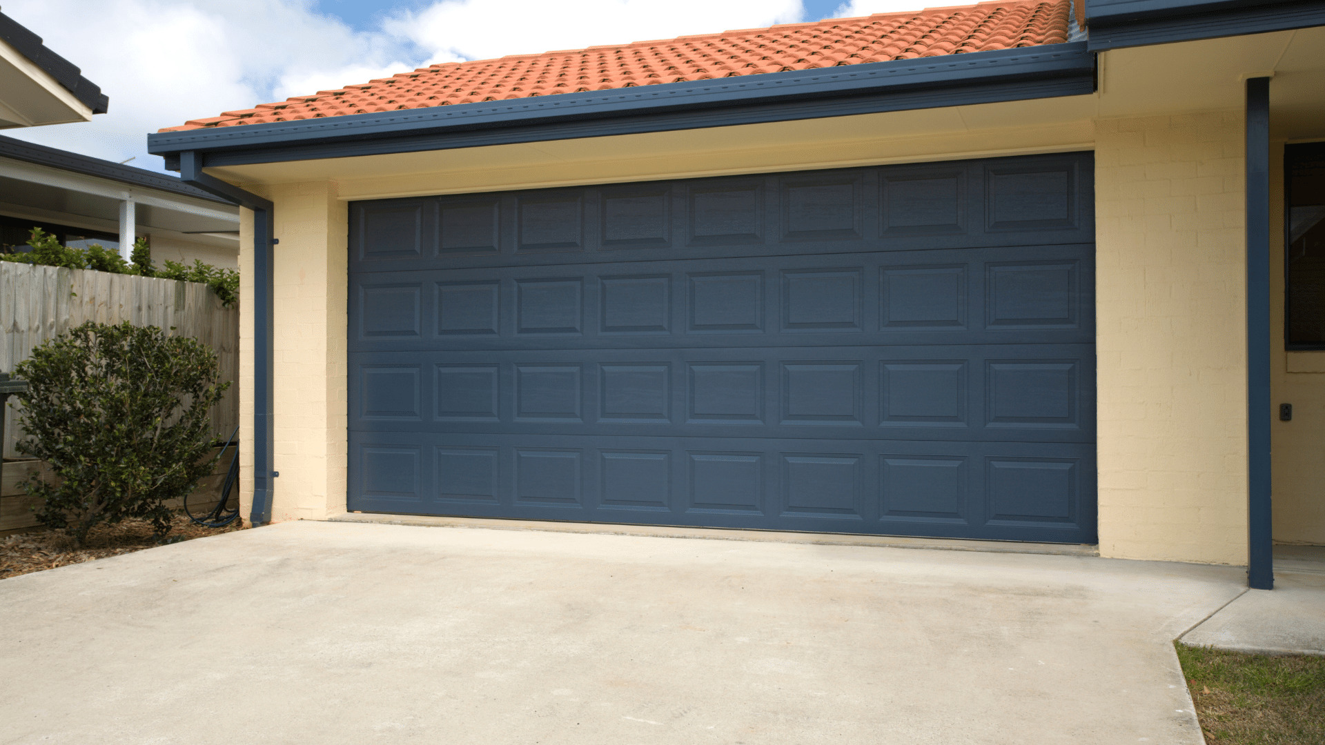 Dark blue sectional garage door on a Newcastle home